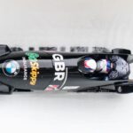 Bobsleigh carrying two athletes in GB kit