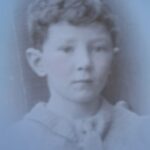 Black an white portrait of young boy with curly hair